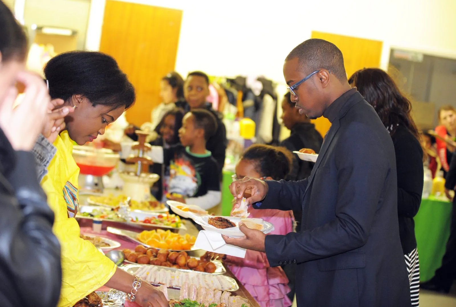 Families sharing food at the MEG community Christmas party