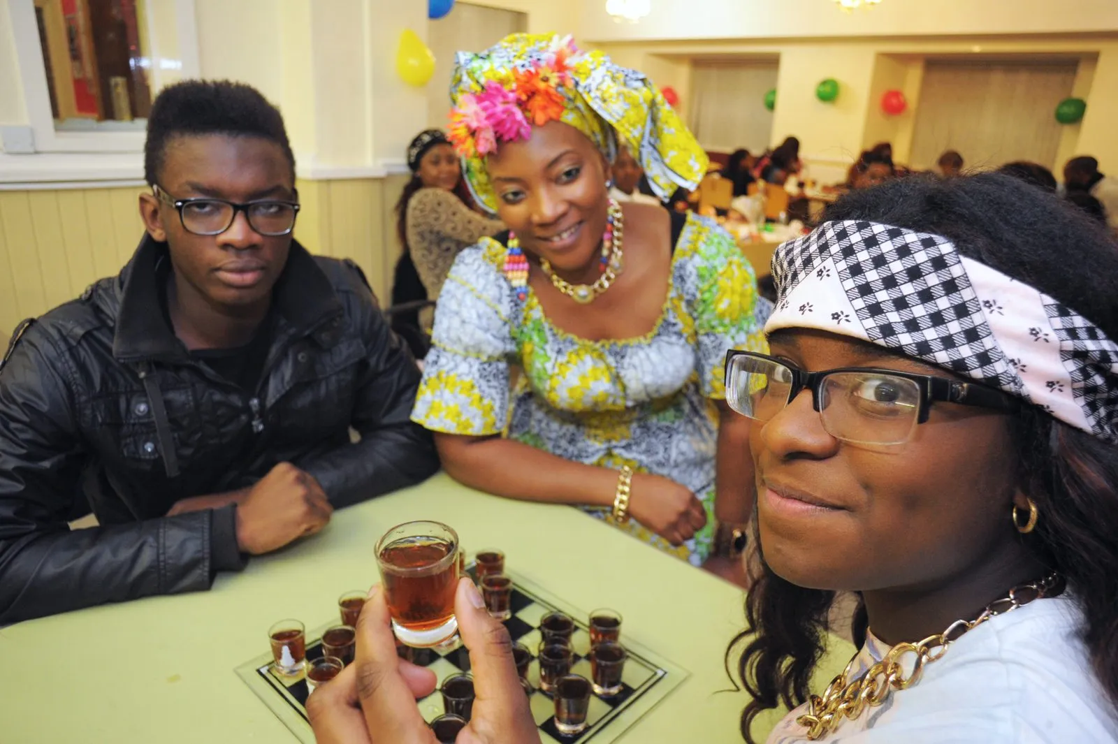 Young people and a volunteer at a MEG community event