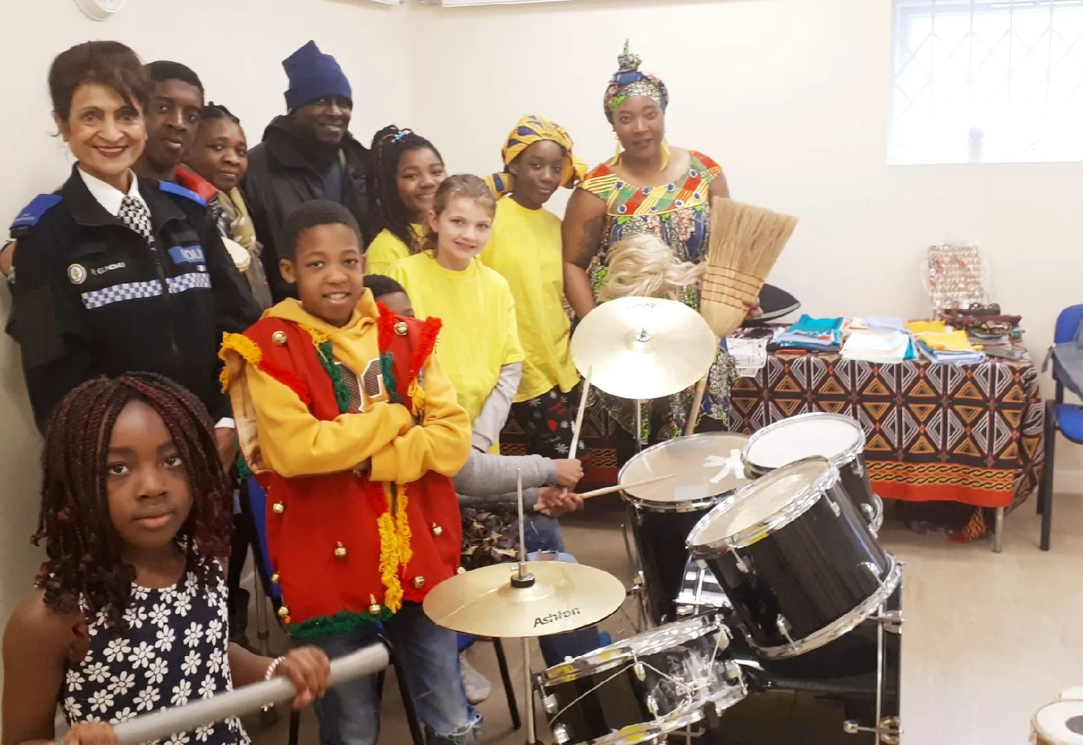 Children and volunteers playing drums at a MEG music session